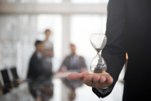 Businessman holding an hour glass