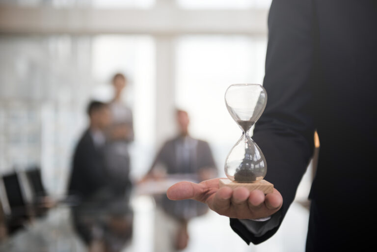 Businessman holding an hour glass